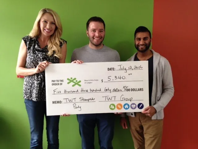 Three people holding a large cheque for $5,340 made out to Boys & Girls Clubs of Calgary, dated July 12, 2016.